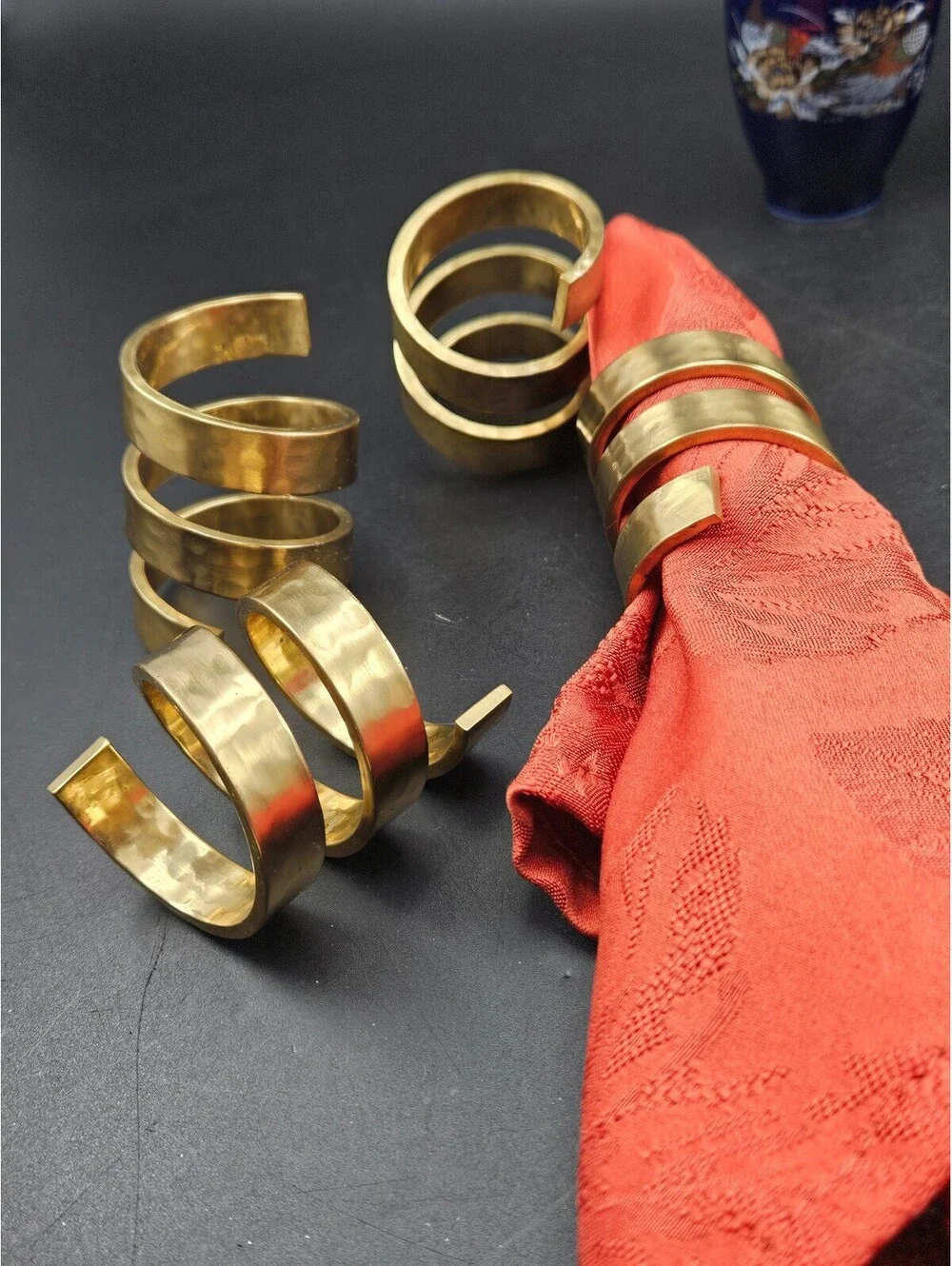 Set of 4 Spiral Hammered Brass Napkin Rings and 4 Red Napkins